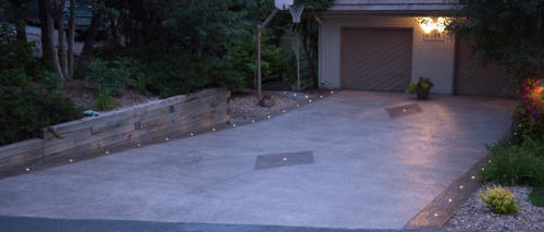 LED landscape lights: DEKOR Dek Dots illuminate a stamped concrete driveway at night